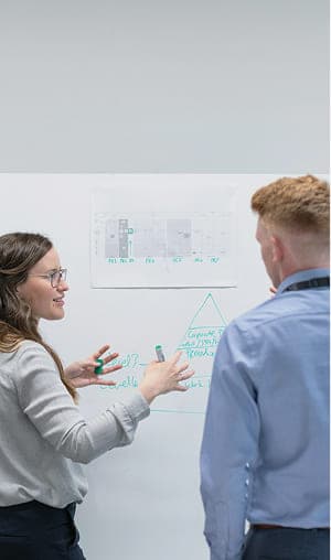 ホワイトボードを使ってミーティングをする二人のビジネスパーソン